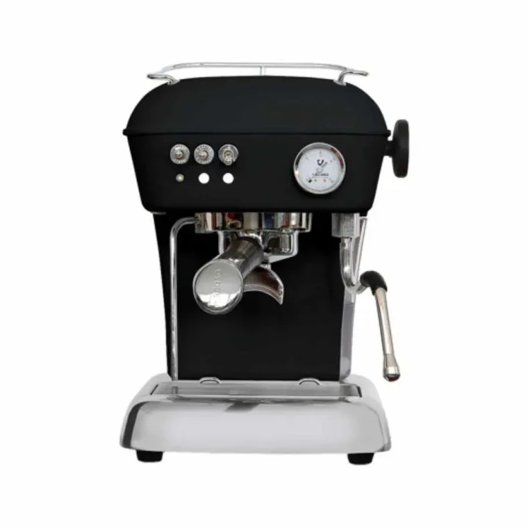 The Ascaso Dream One espresso machine photographed head-on against white: a matte black body on a polished chrome base, three buttons and a pressure gauge across the front, a chrome portafilter under the group head and a steam wand on the right