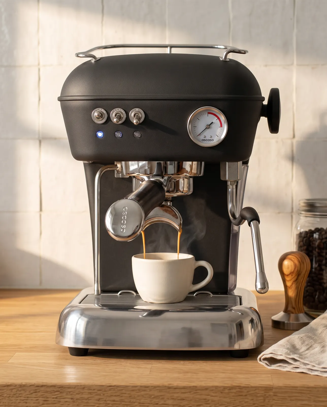 The machine on a kitchen counter, pulling a shot into a white cup