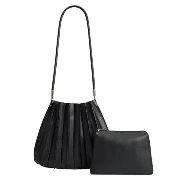 A black pleated vegan leather shoulder bag with a long strap, beside its matching zip pouch, on a plain white background